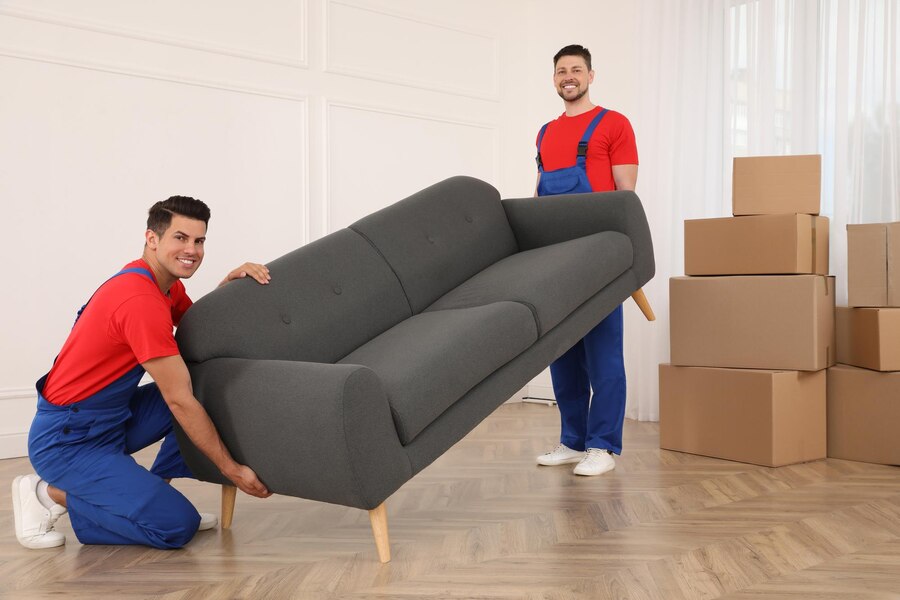 professional-movers-carrying-sofa-new-house_495423-38422